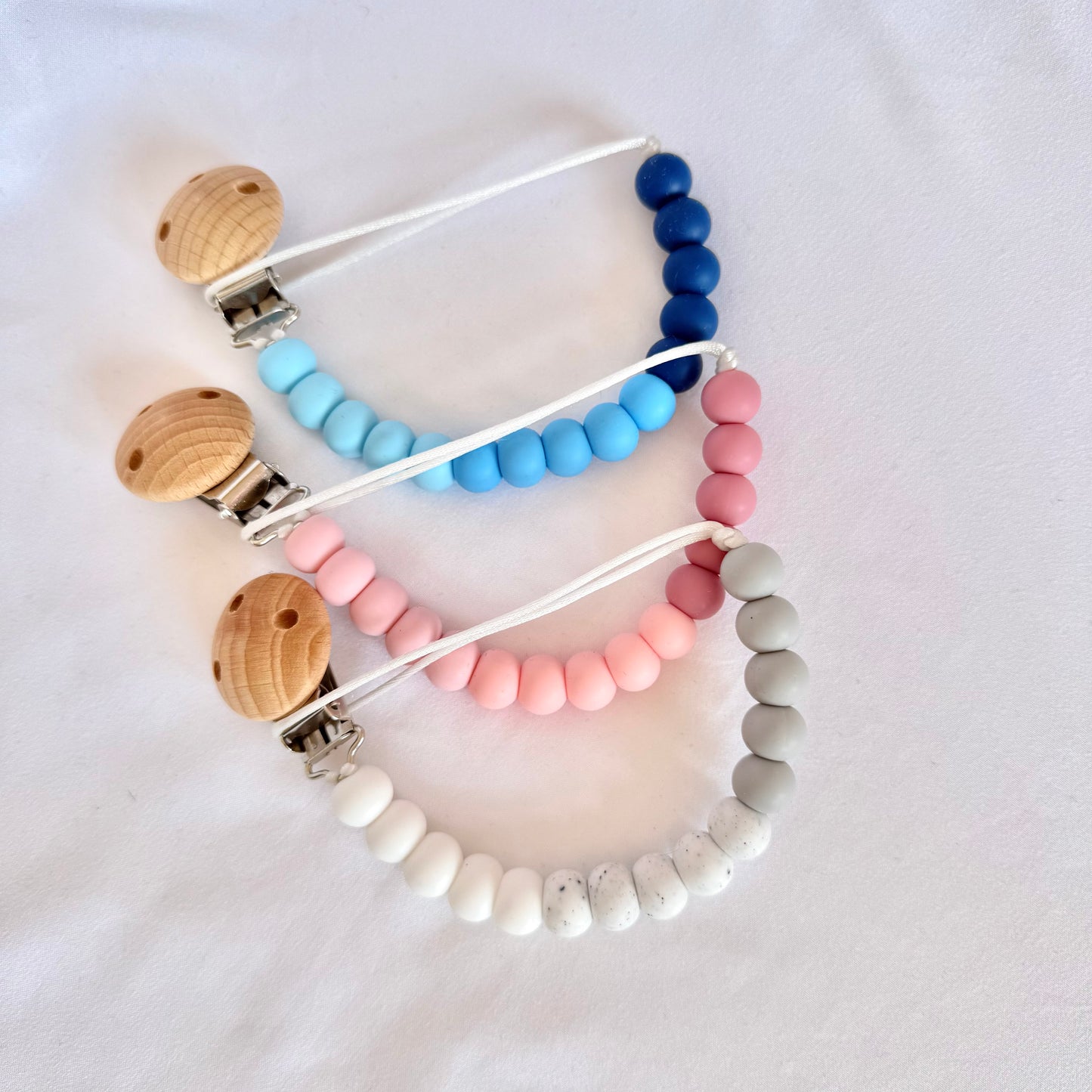 Silicone Beaded dummy clips, with a wooden clip to hold baby's dummy from dropping on the floor.